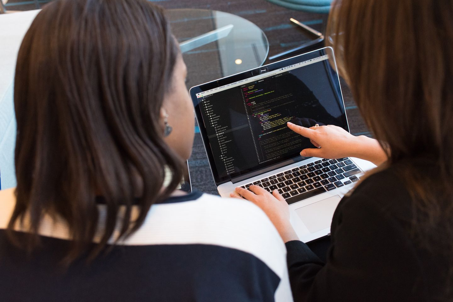 People reviewing software on a laptop