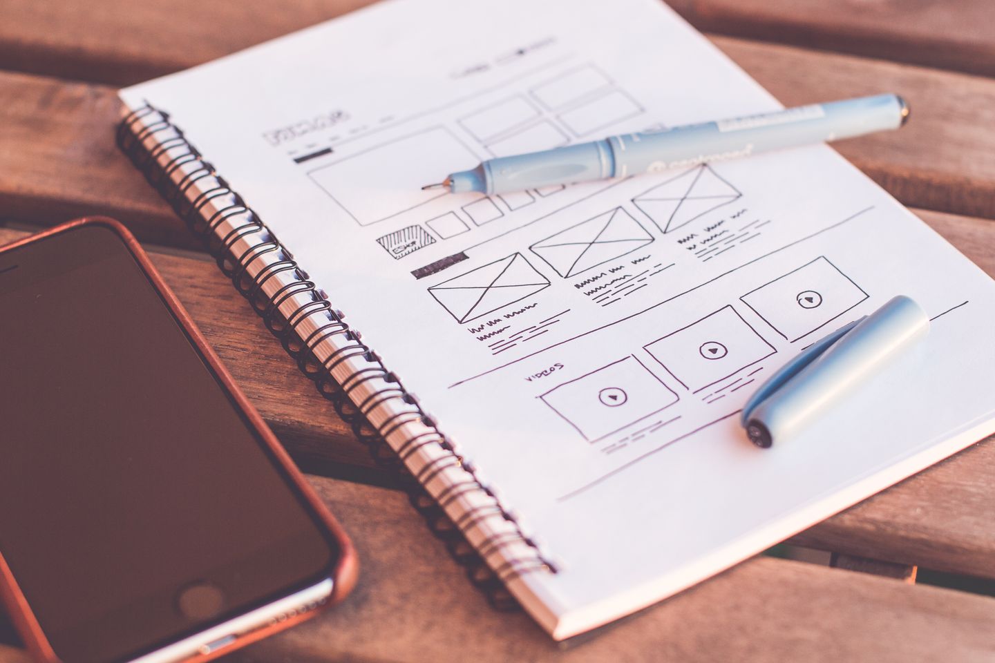 A website wireframe sketched on paper