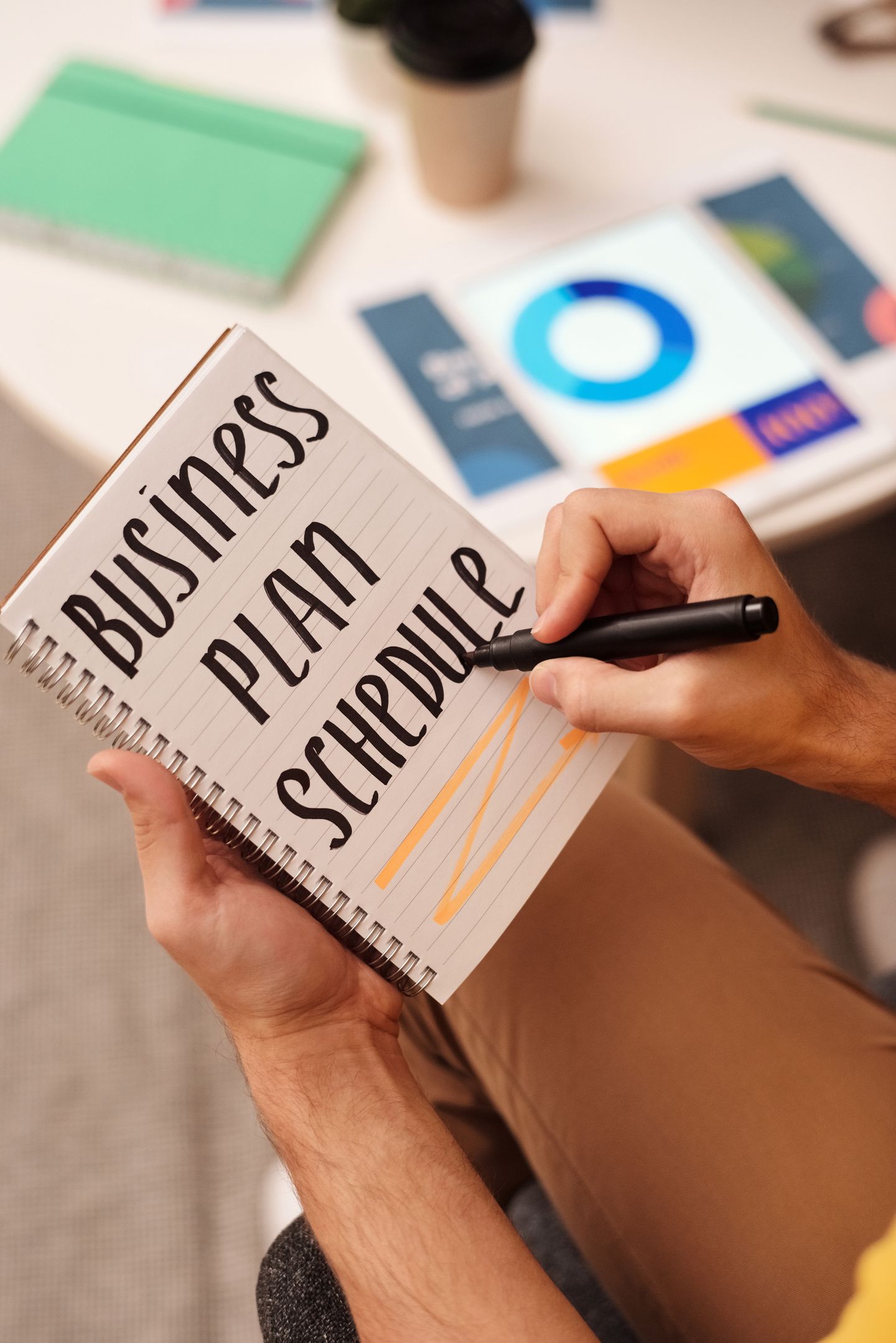 A business plan and schedule written in a notebook